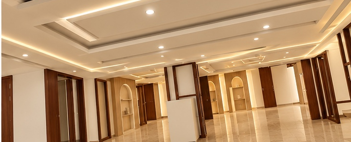 Modern ceiling with recessed LED downlights and concealed LED strip lighting installed by Sha Technical Solutions Ltd.